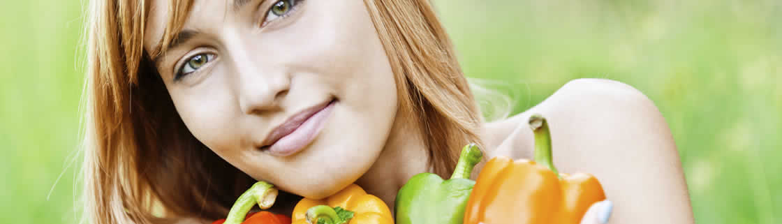 A woman holding fresh vegetables