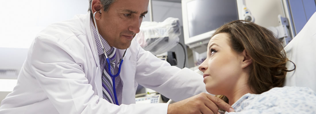 Doctor examining woman for heart